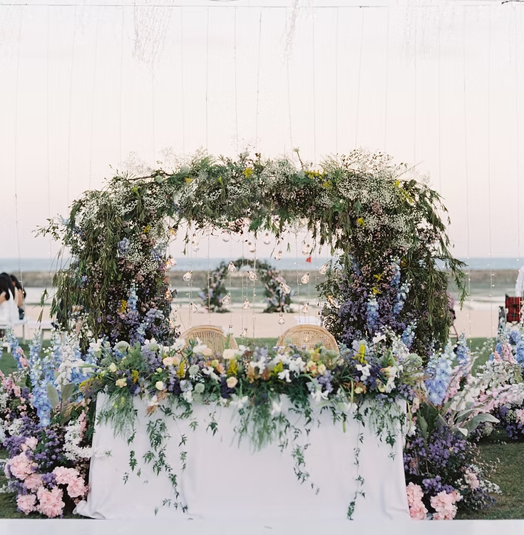Floral arch and aisle florals styled for the ceremony