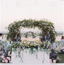 Floral arch and aisle florals styled for the ceremony